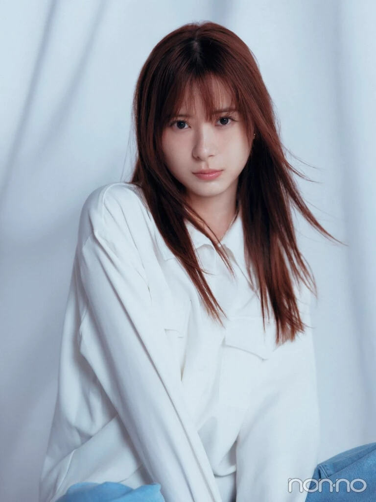 白シャツとデニムで座り、こちらを見据えるモーニング娘。’25生田衣梨奈さん。