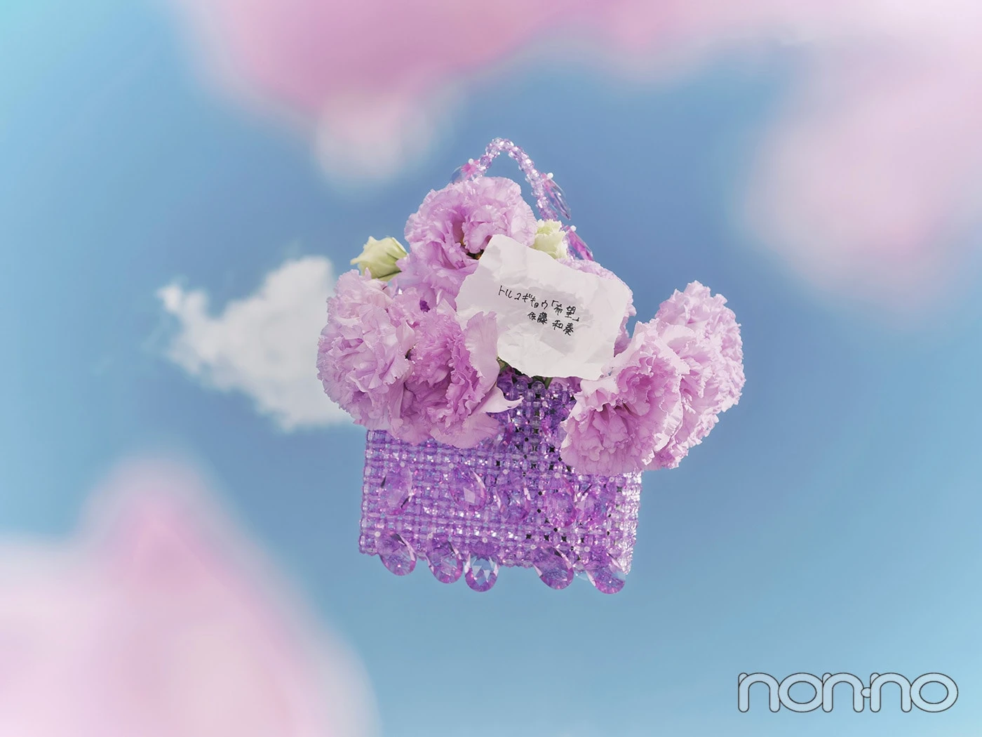 トルコギキョウの花言葉を綴った紙が入った紫のバッグが宙に舞う写真