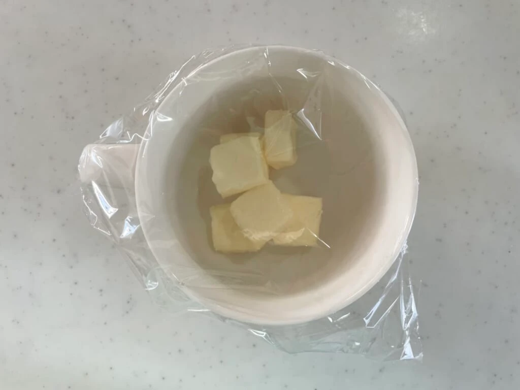 バターを入れた耐熱皿にラップをかける