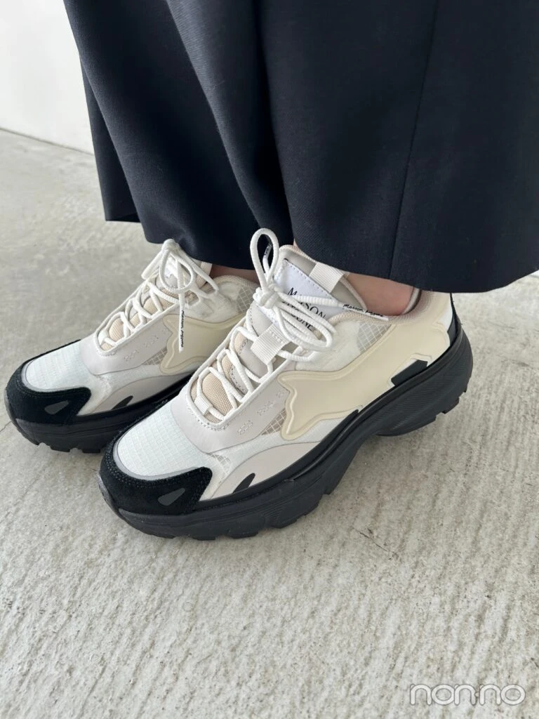 黒いソールの白スニーカーの足元寄り